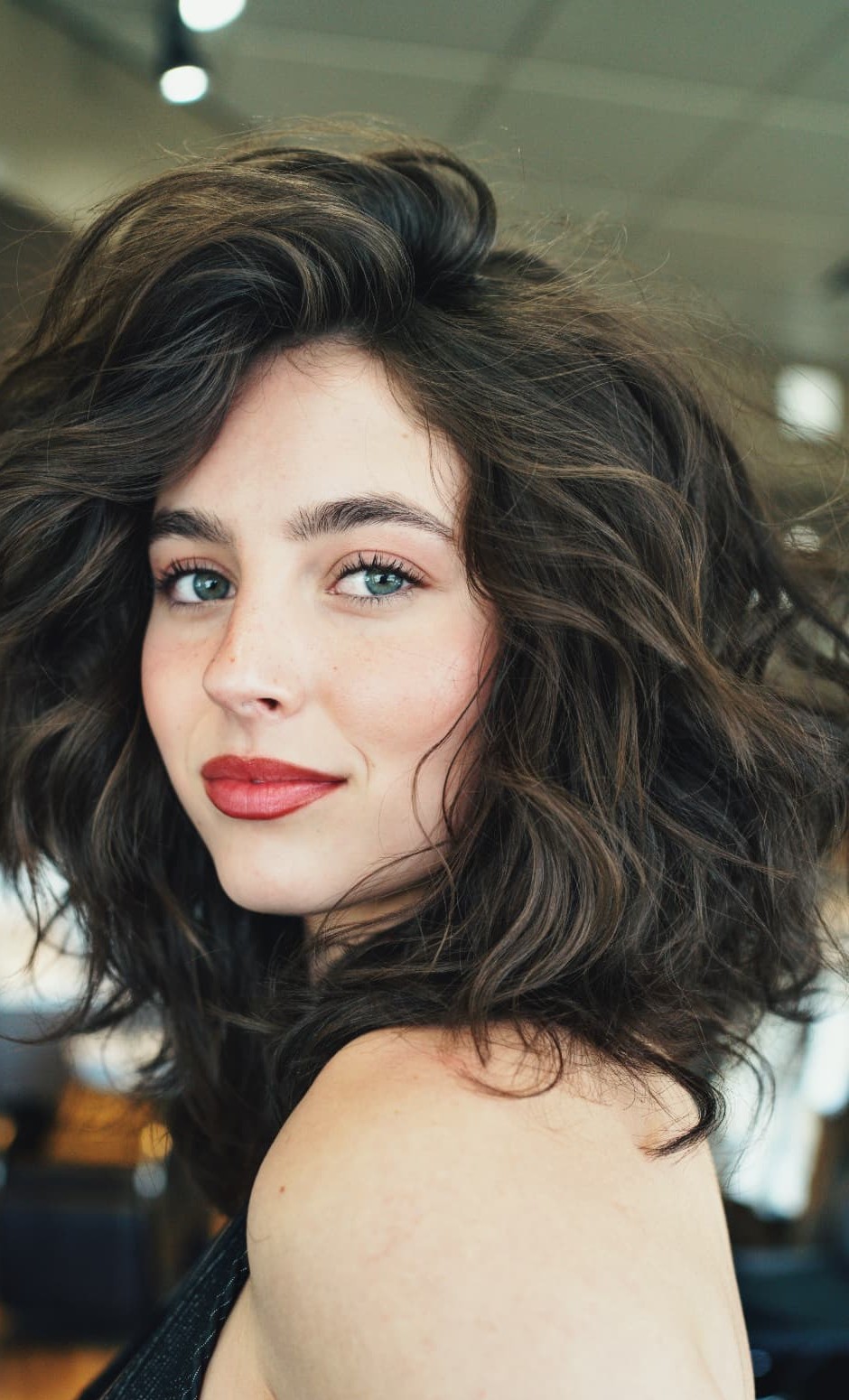Brunette voluminous wavy bob cut by a Bob Company certified stylist
