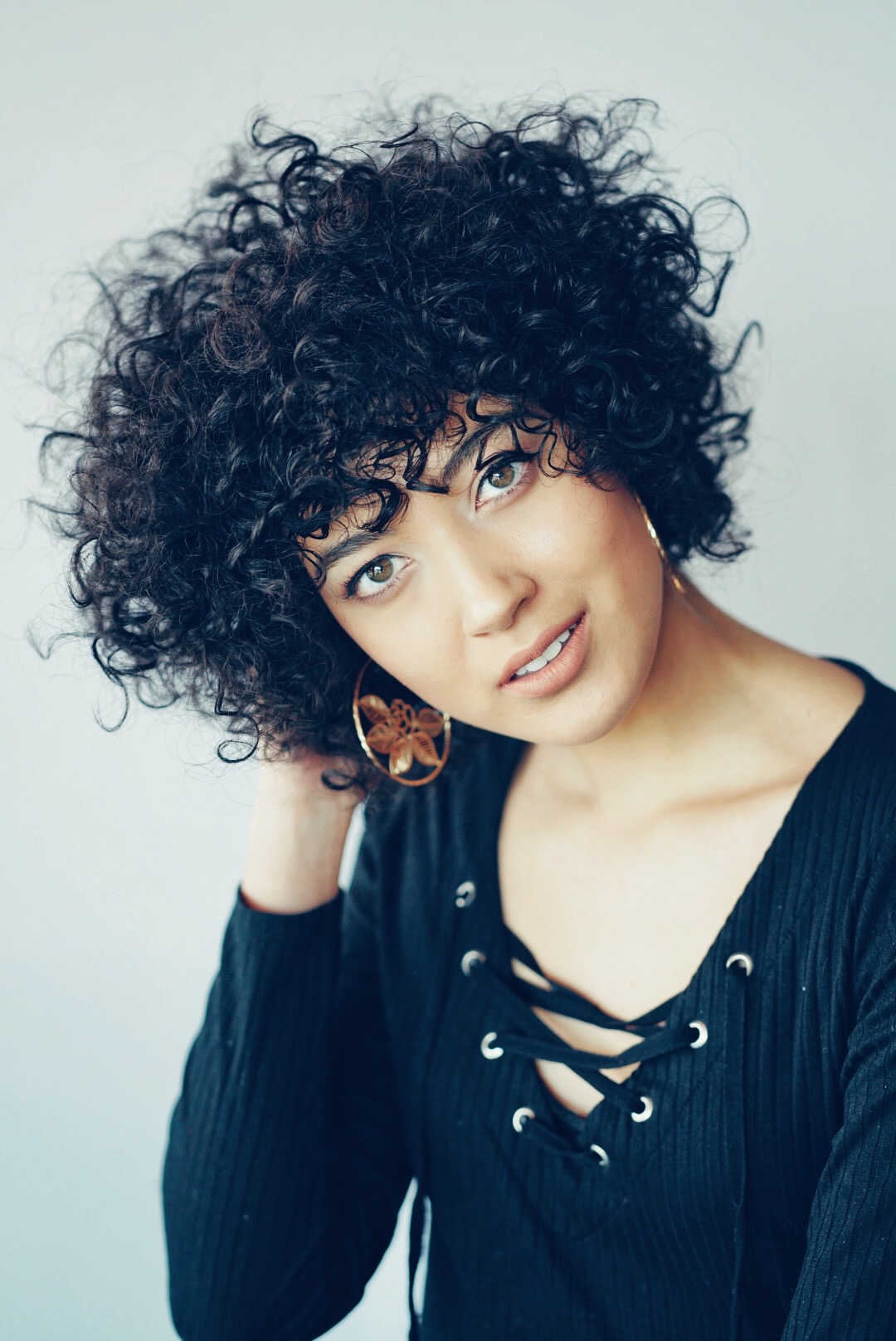 Full curly dark shag with a soft fringe