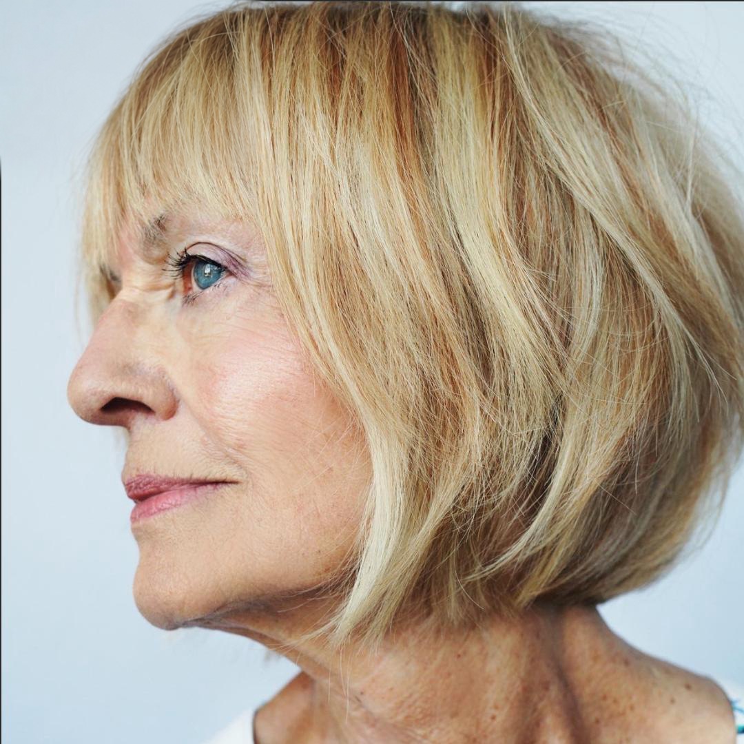 Blonde layered bob with a light fringe, seen in profile